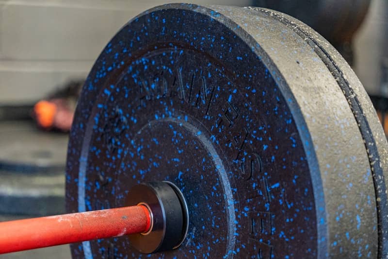 A barbell loaded with weight plates.