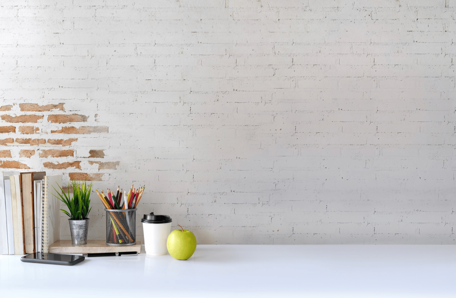 pink mug on stacked books
