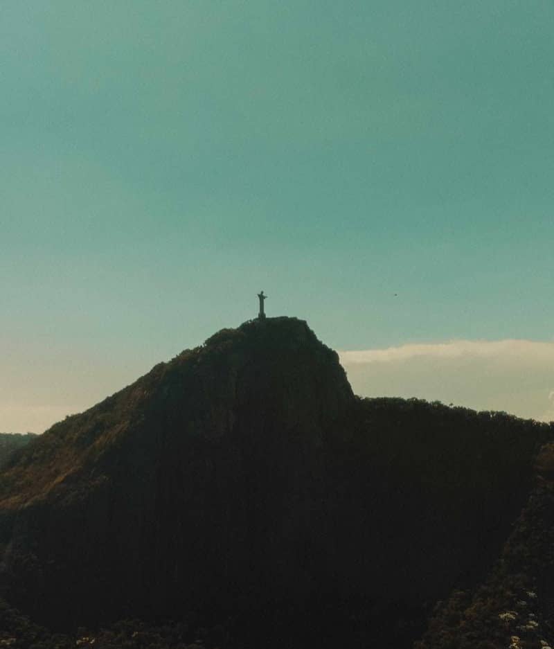 Christ the redeemer atop a mountainous landscape.