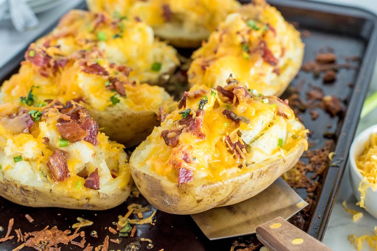 twice baked ranch poatoes on a baking sheet with a spatula under