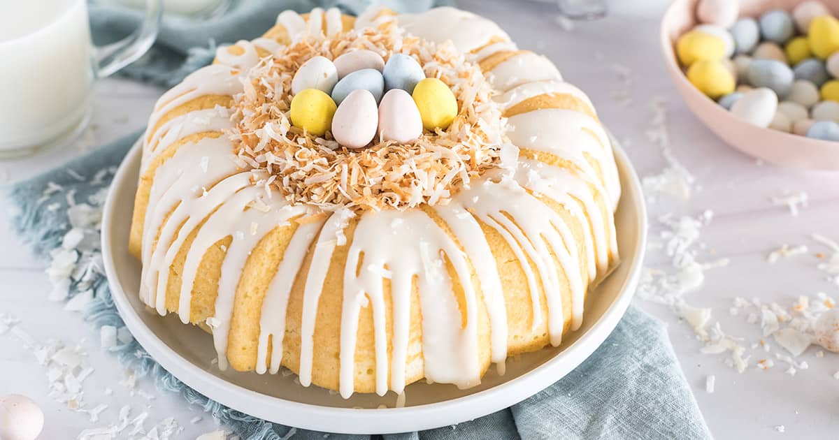 close-up of our Coconut Bundt Cake dressed up for Easter with a little "nest" of toasted coconut and cadbury mini eggs