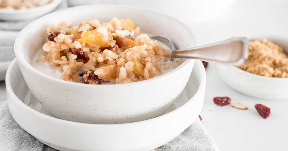 A white bowl filled with apple cherry breakfast risotto