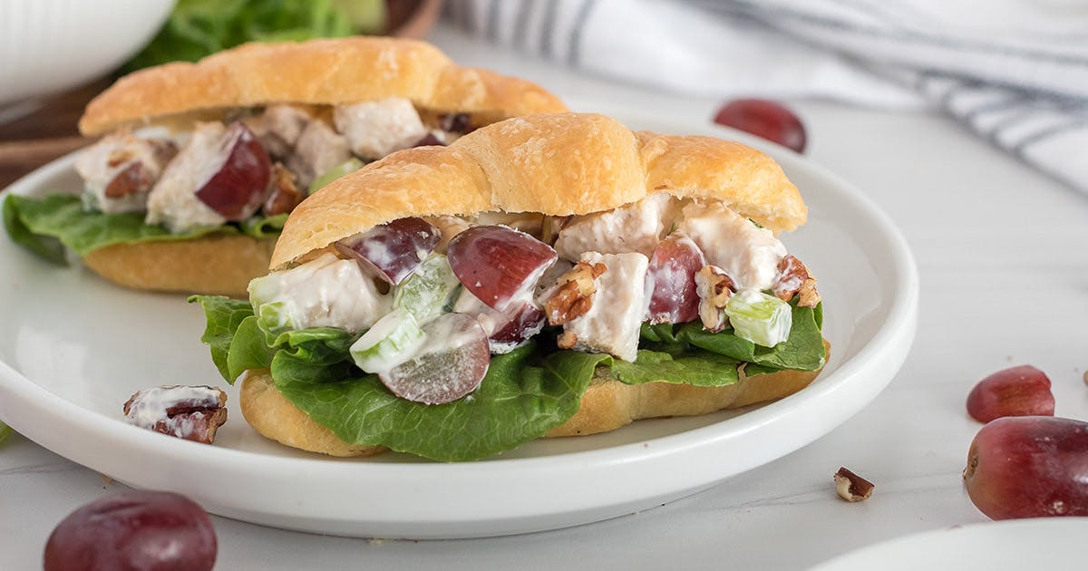 plate of chicken salad sandwiches on mini croissants