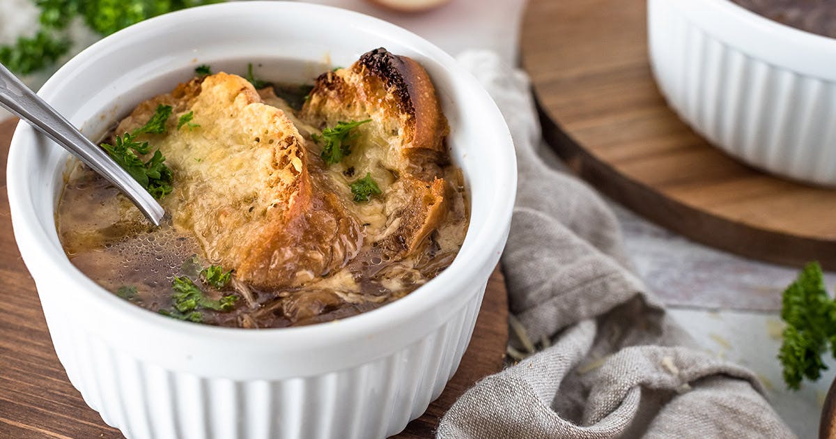 close-up of a white ramekin filled with Instant Pot French Onion Soup