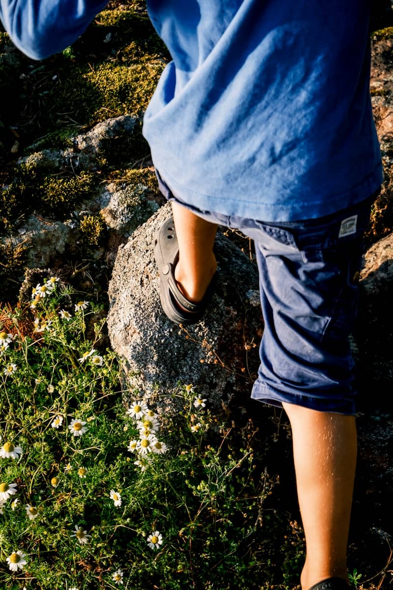 Child climbing over rocks in nature