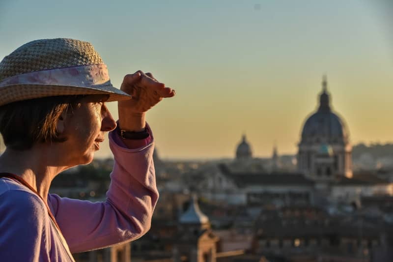 Woman in hat looking over cityscape at city skyline