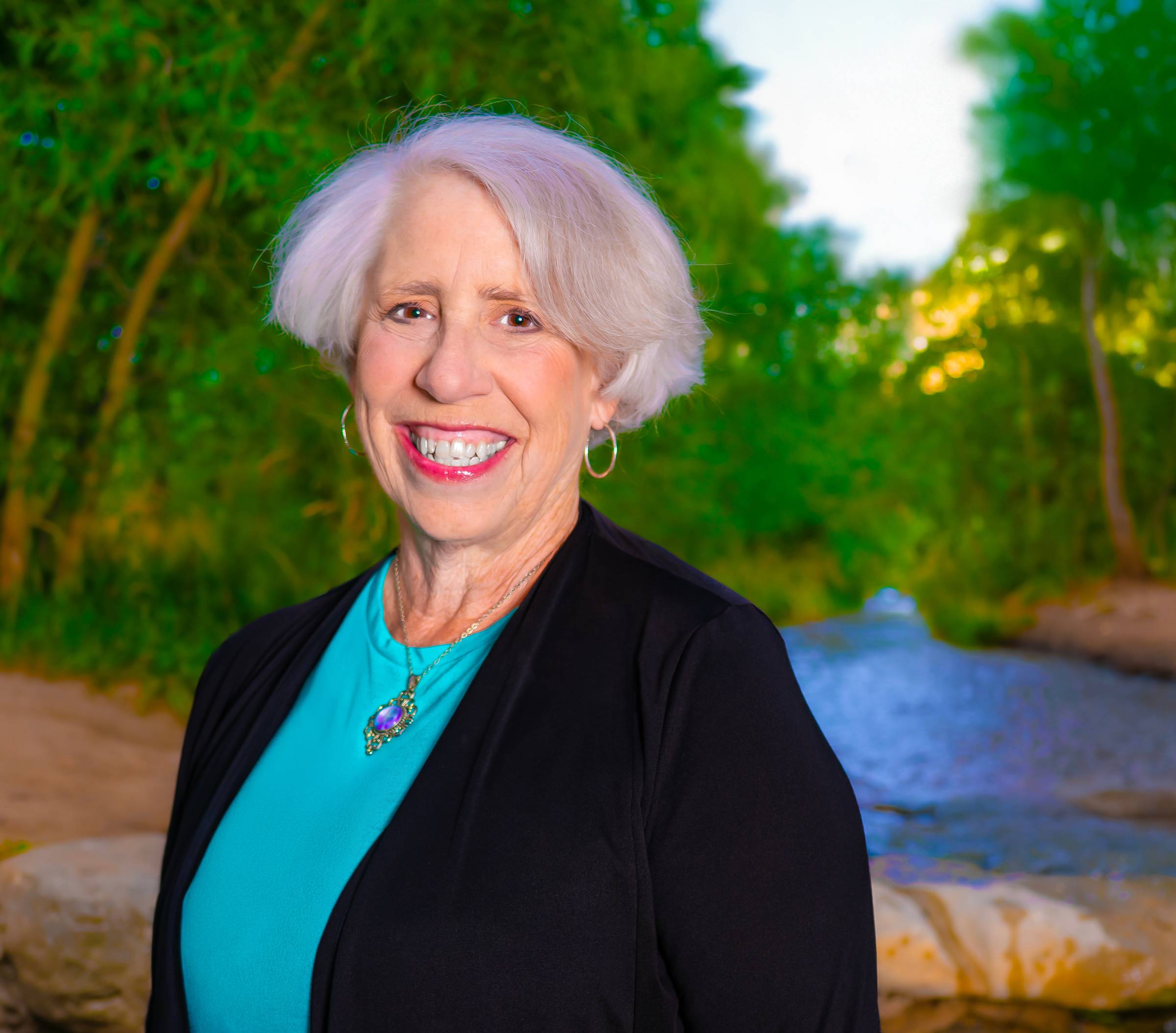 woman with trees and water in background