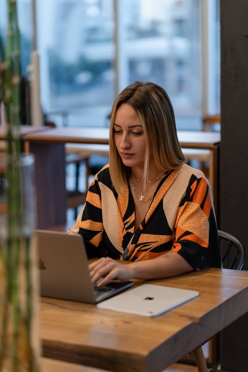 A woman works on her laptop in a cafe.