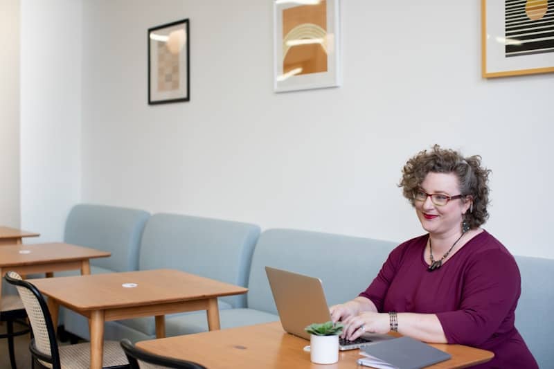 Woman Smiling Using Laptop