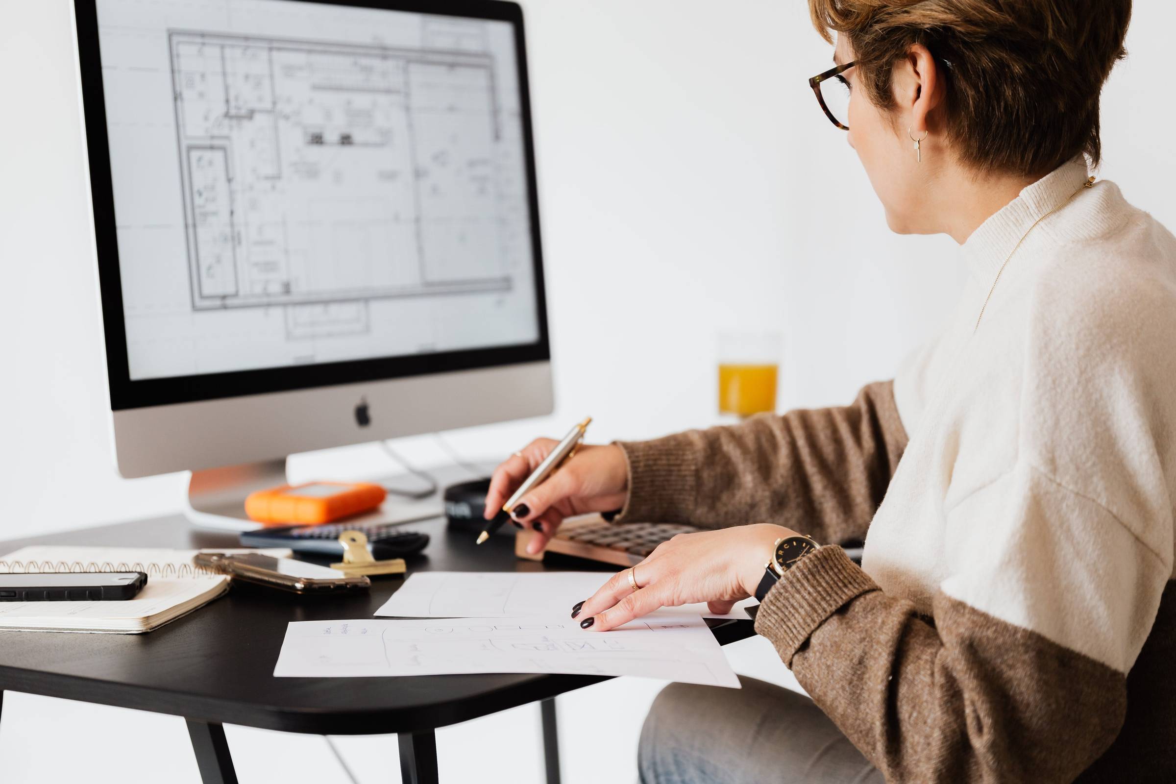 Woman Taking Notes at Computer