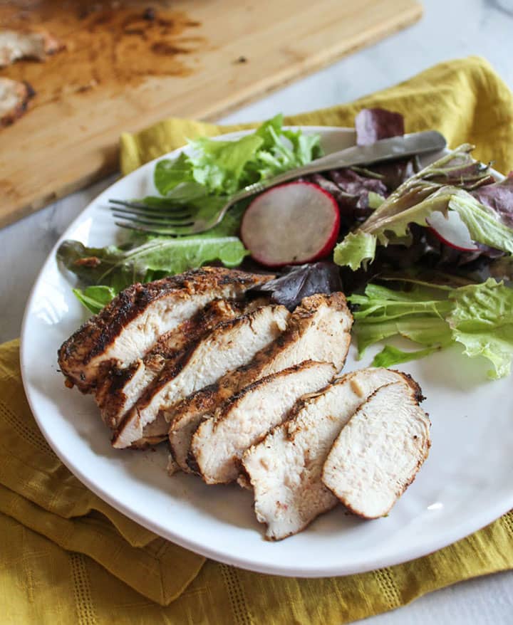 sliced grilled jerk chicken breast on a plate