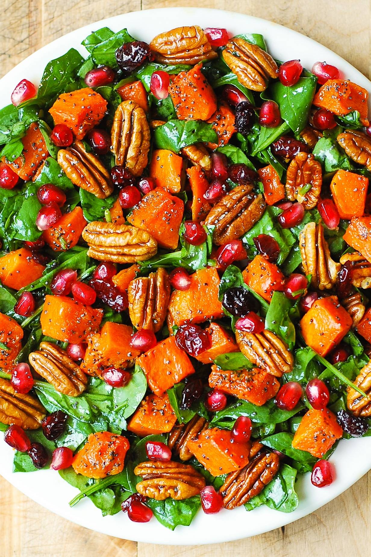 Roasted Butternut Squash and Spinach Salad with Pecans, Cranberries, Pomegranate Seeds, and Poppy Seed Honey-Lime Dressing.