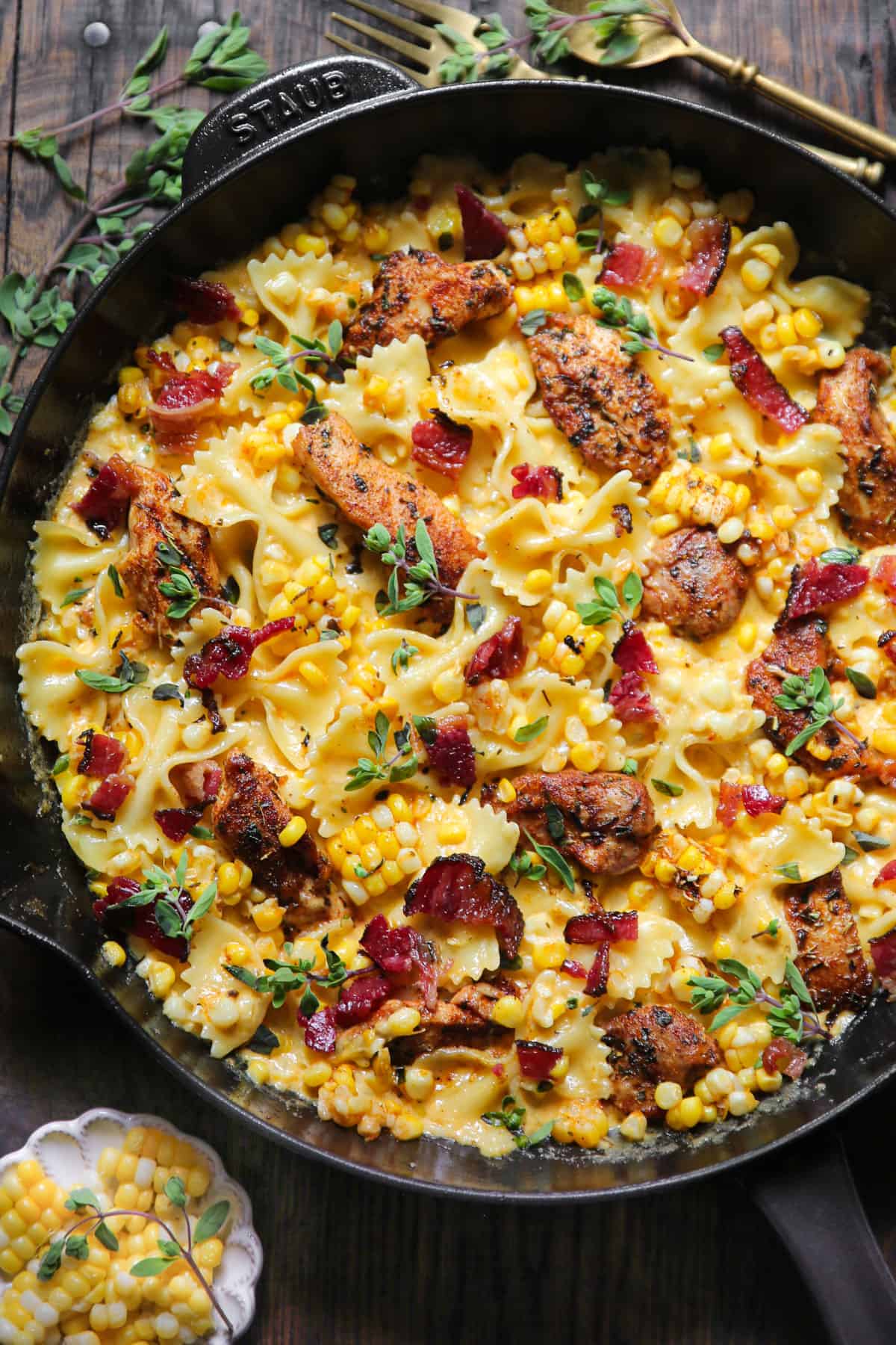 Creamy Chicken and Corn Pasta with Bacon in a cast iron skillet.