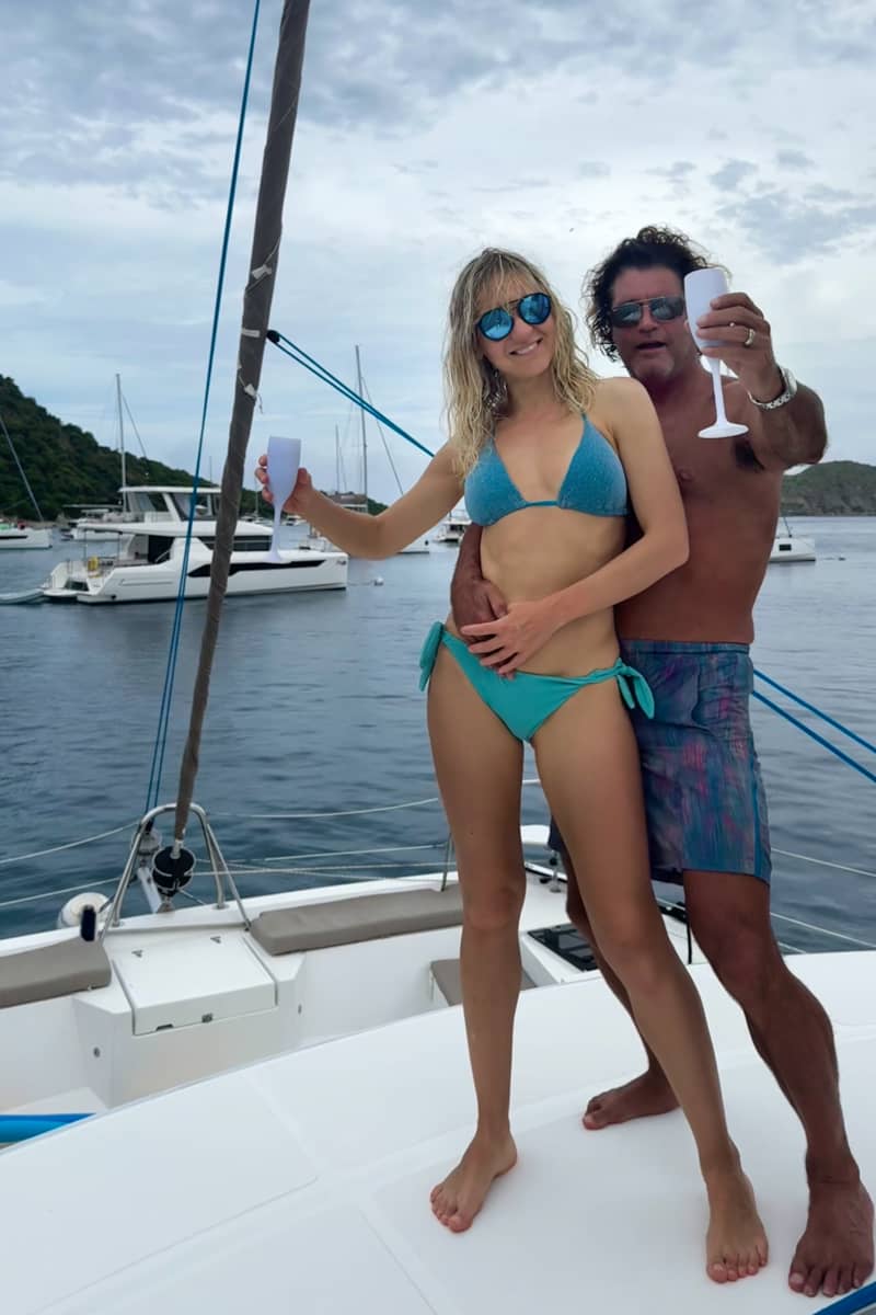 Julia and her husband in swimsuits on the boat