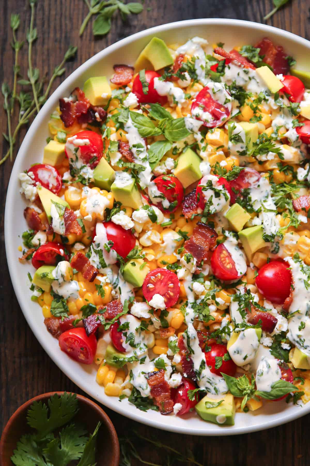 Avocado Corn Tomato Salad on a white plate.