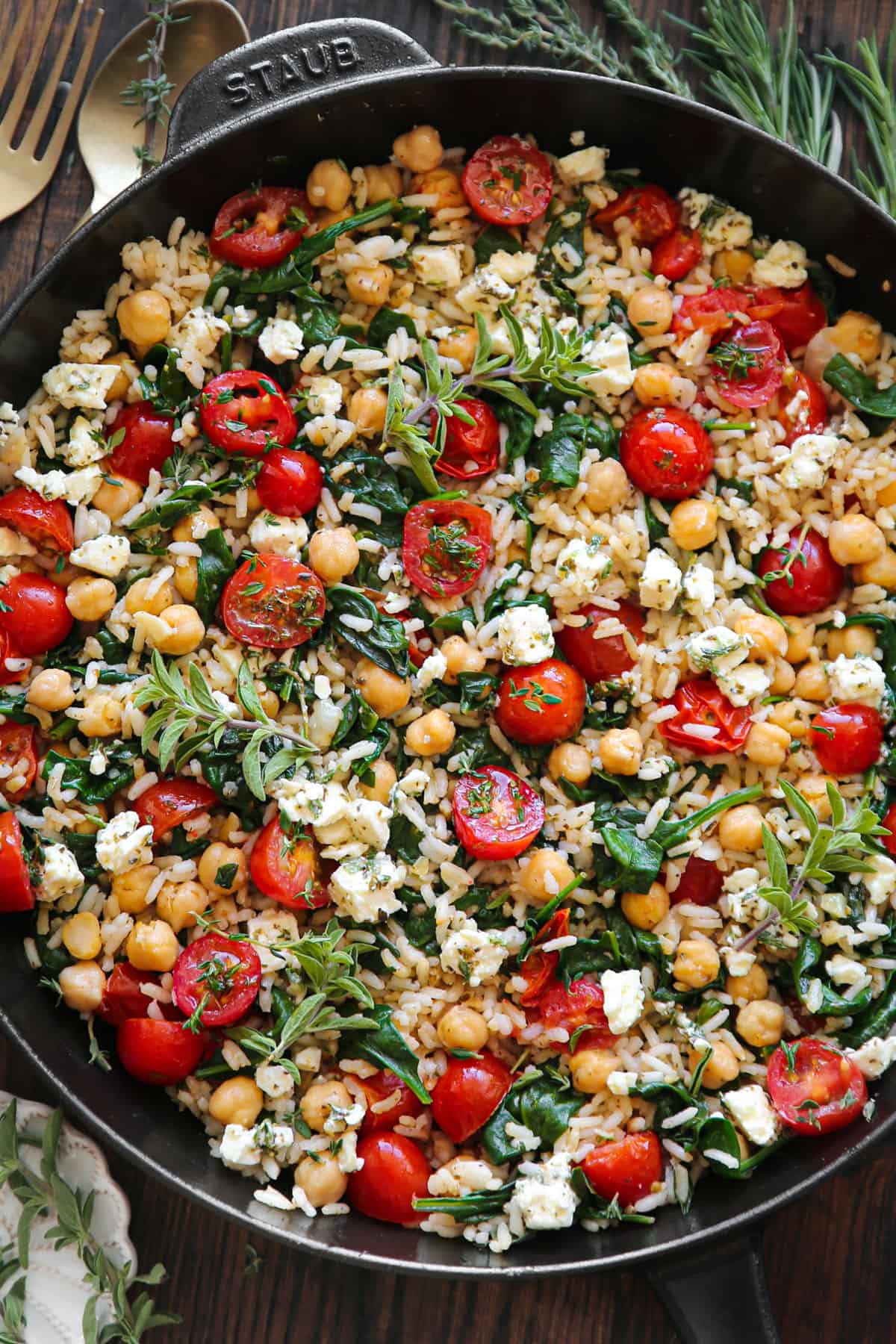 Mediterranean Lemon Rice with Chickpeas, Spinach, Tomatoes, and Feta - in a cast iron skillet.