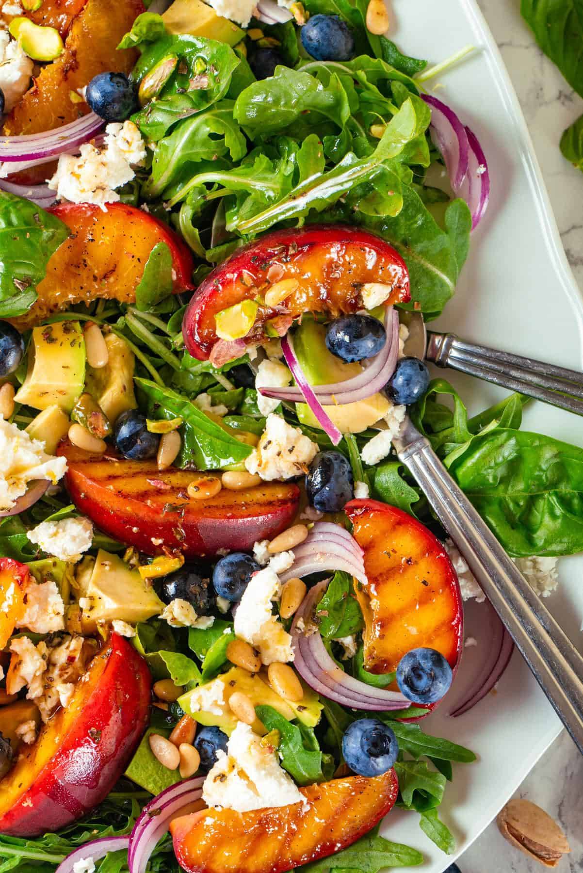 Summer grilled peach salad on a plate.
