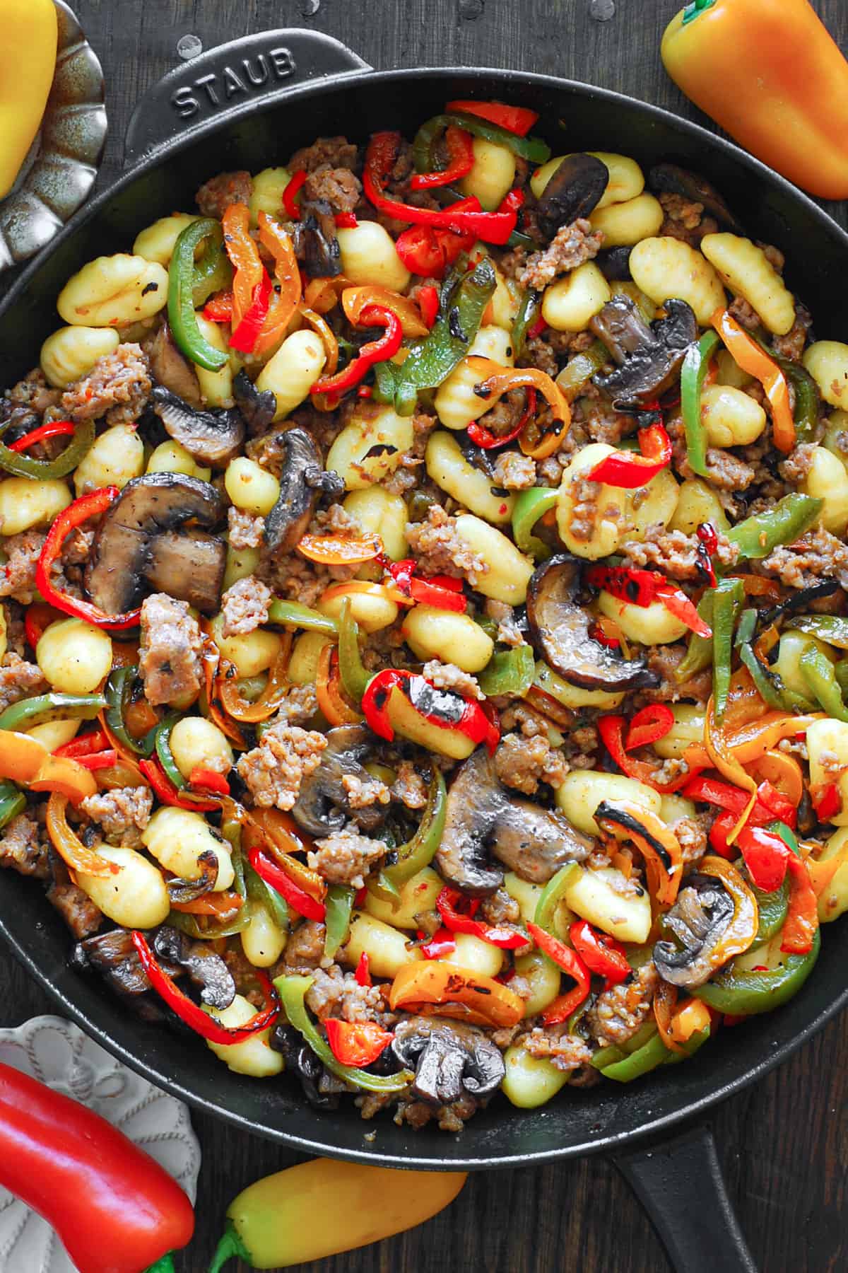 Italian Sausage Gnocchi with Mushrooms and Bell Peppers in a cast iron skillet.