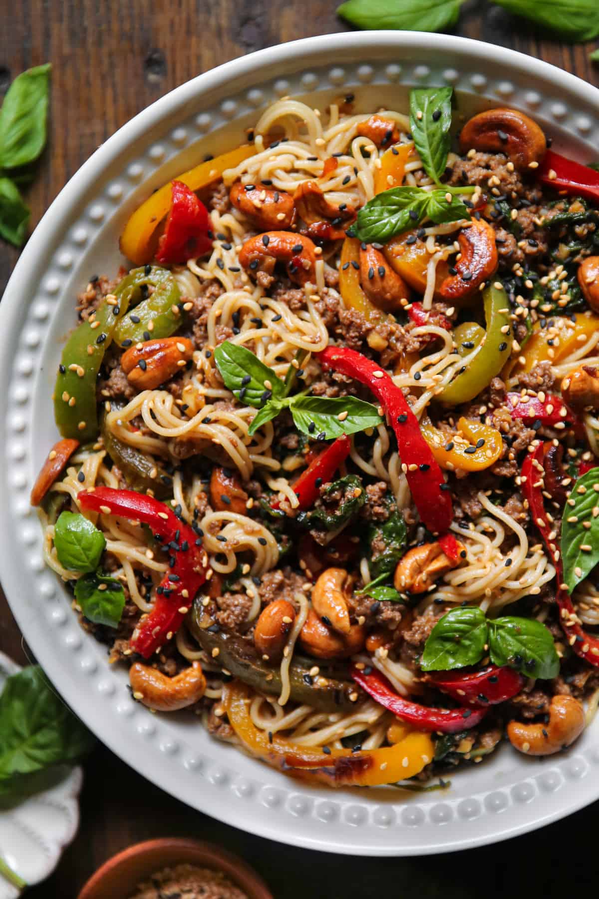 Ground Beef Ramen Noodles with Bell Peppers, Spinach, and Cashews in a bowl.