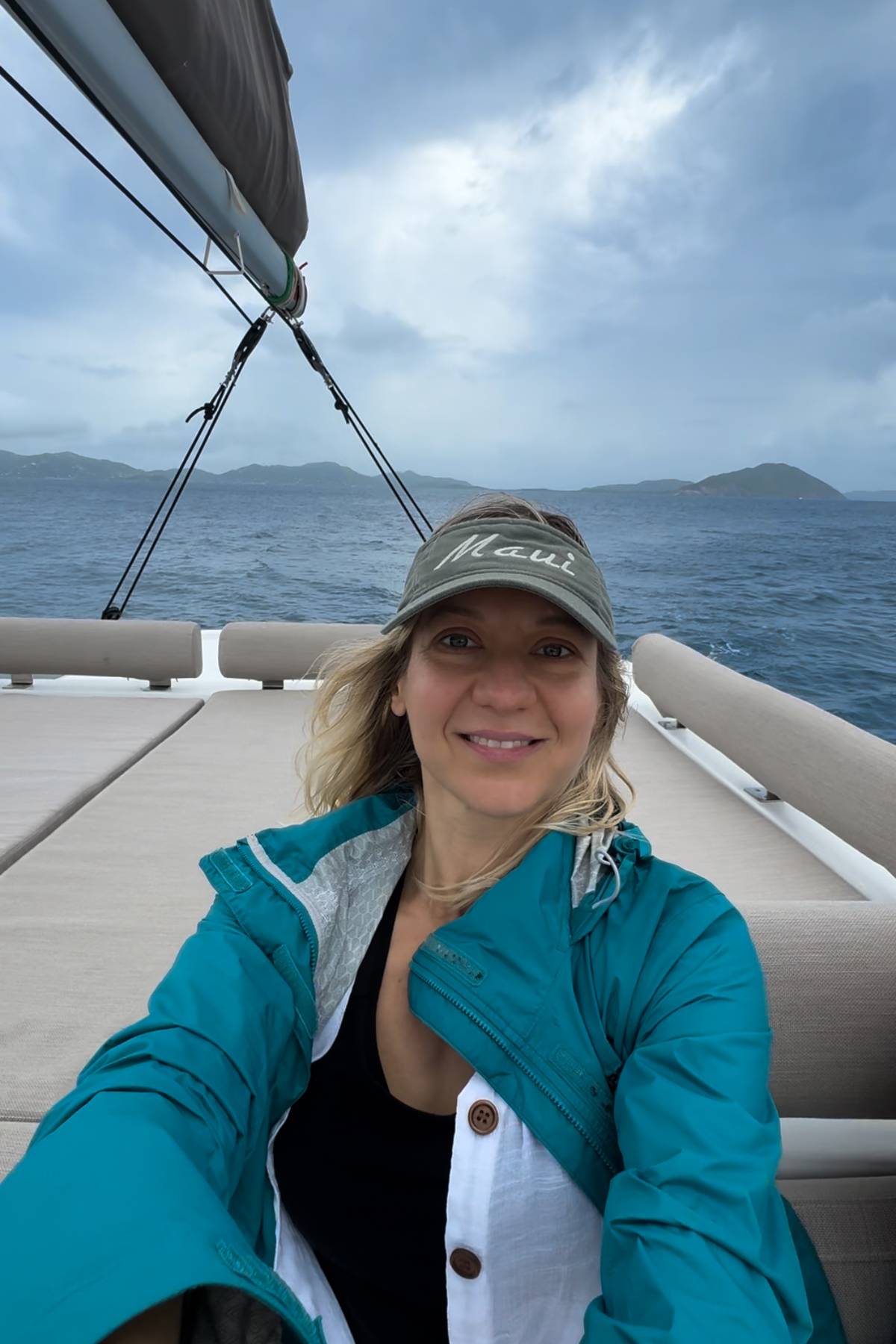 Julia in a rainjacket on the sailboat.