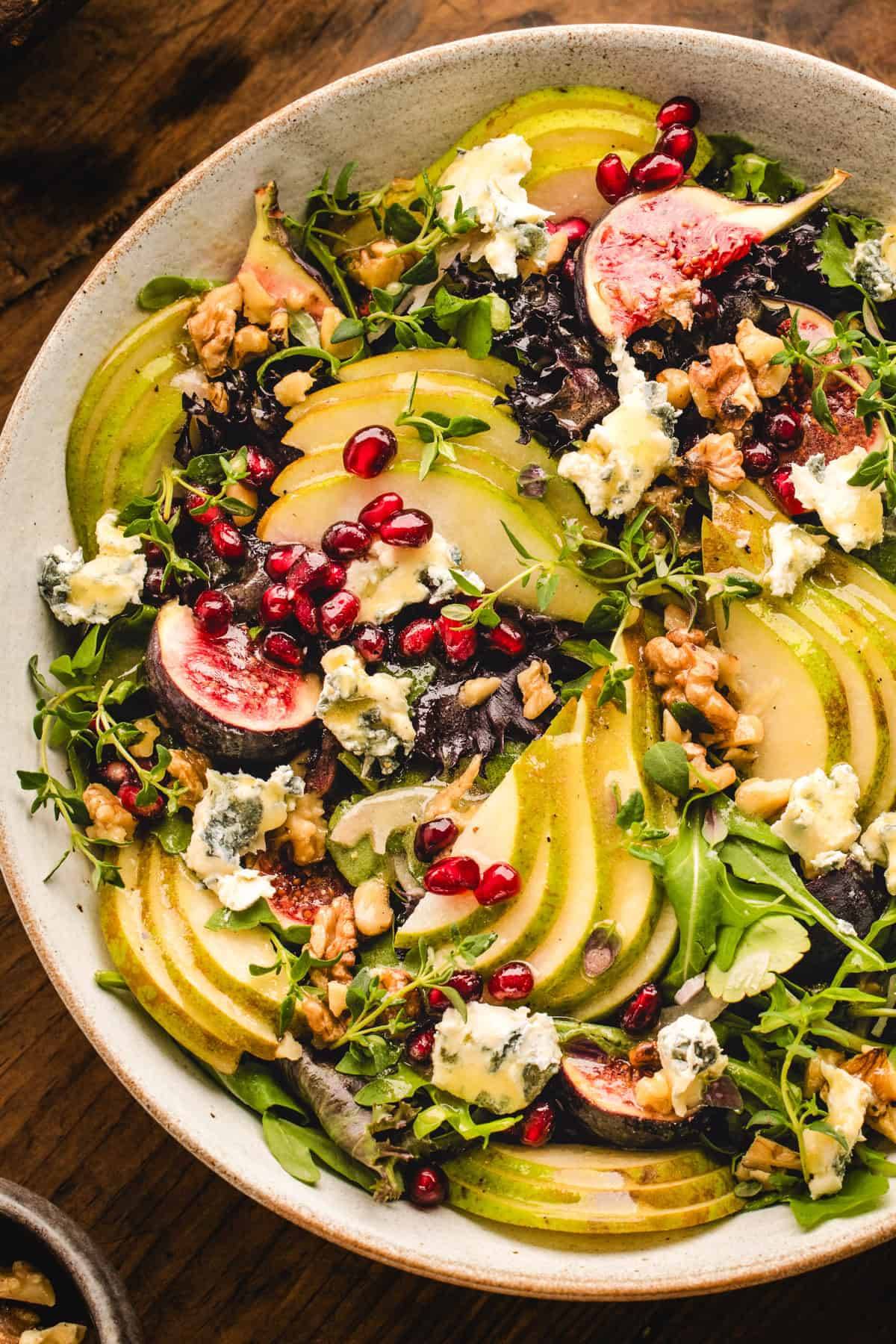 Pear Salad with Walnuts, Blue Cheese, and Honey-Mustard Dressing in a bowl.