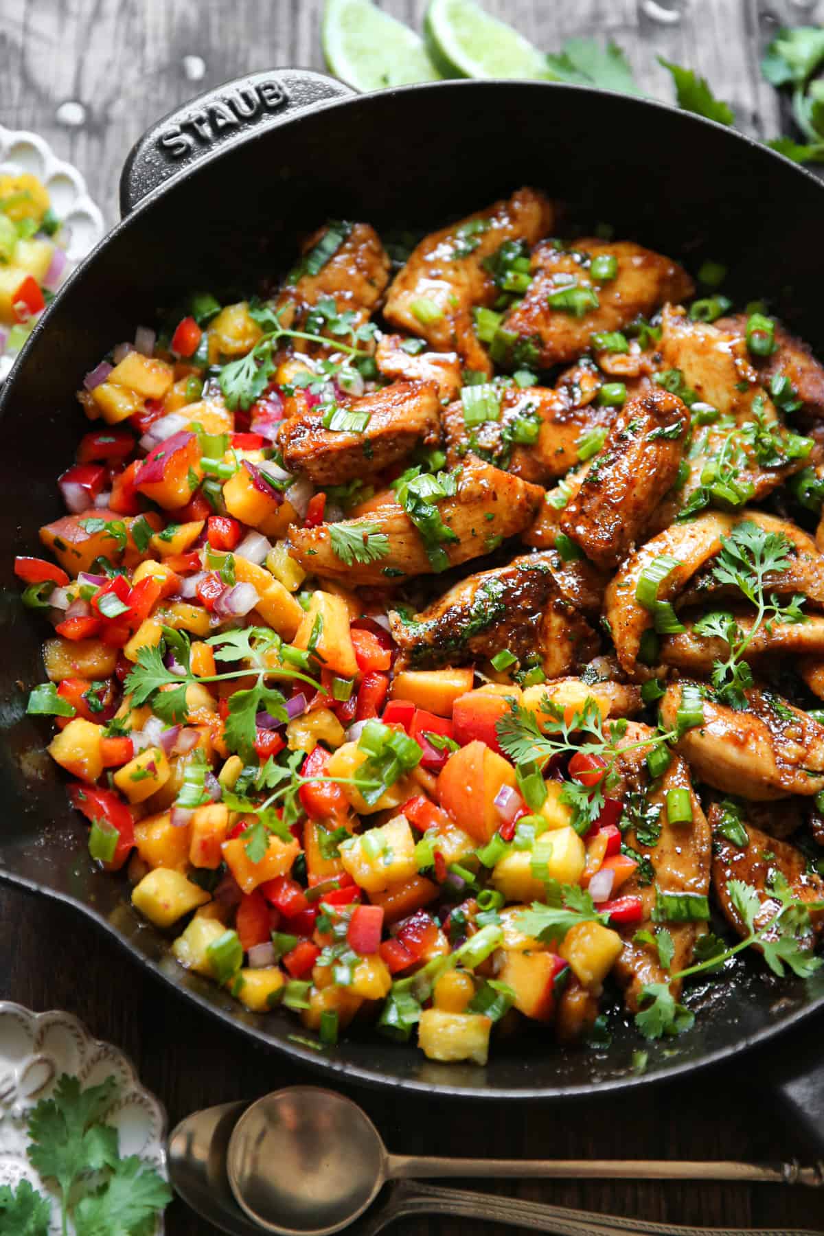 Cilantro-Lime Chicken with Peach Salsa in a cast iron skillet.