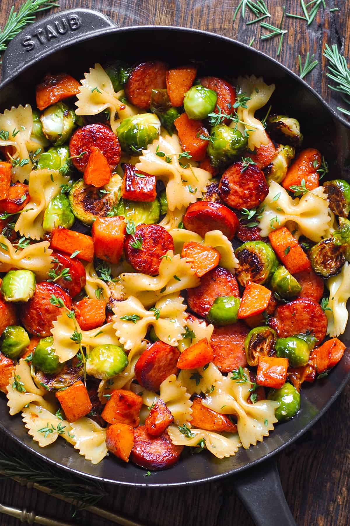 Autumn Dinner with Sausage, Pasta, Brussels Sprouts, and Butternut Squash in a cast iron skillet.