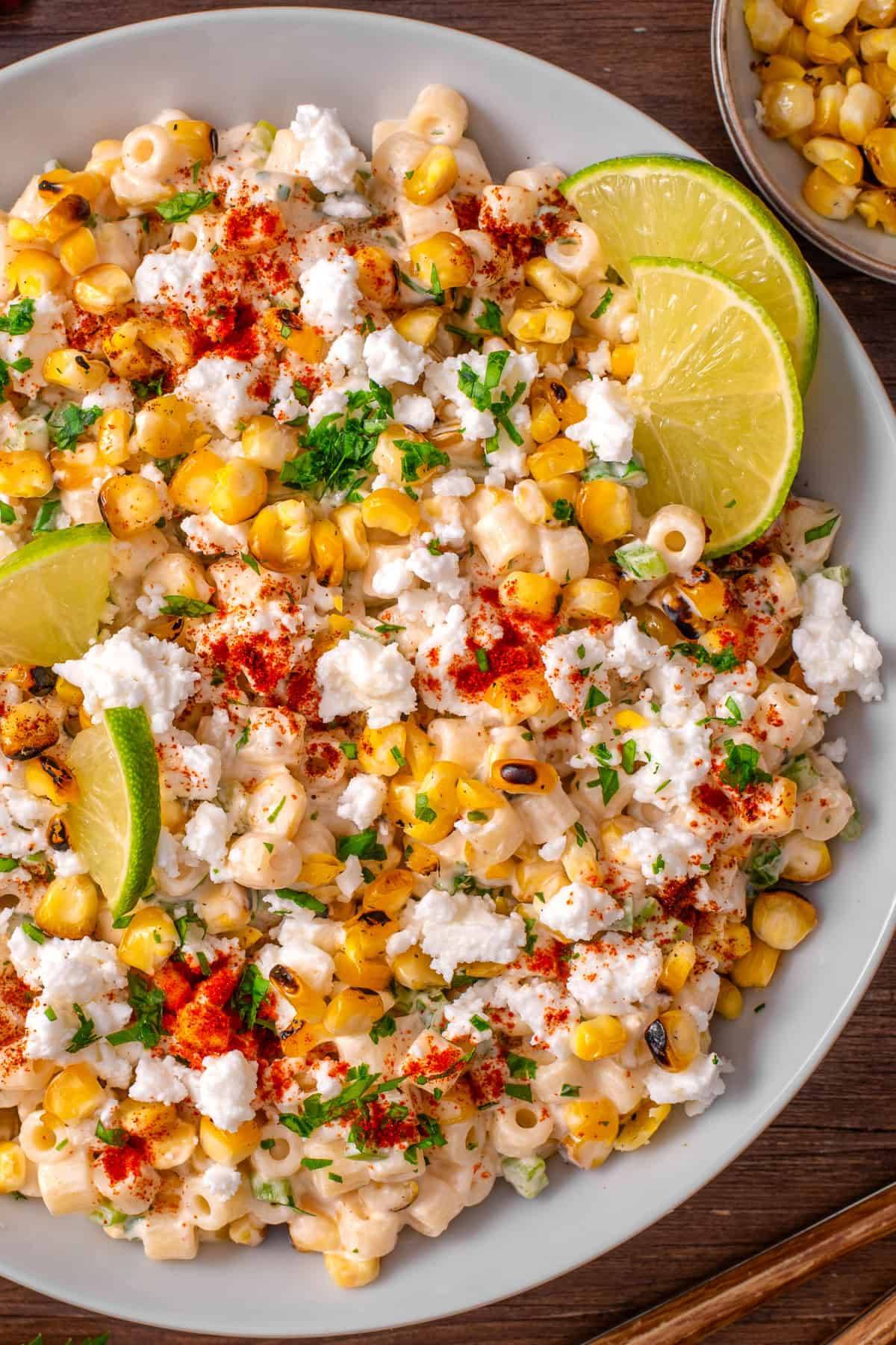 Mexican Street Corn Pasta Salad (with green bell pepper and green onions) on a plate.