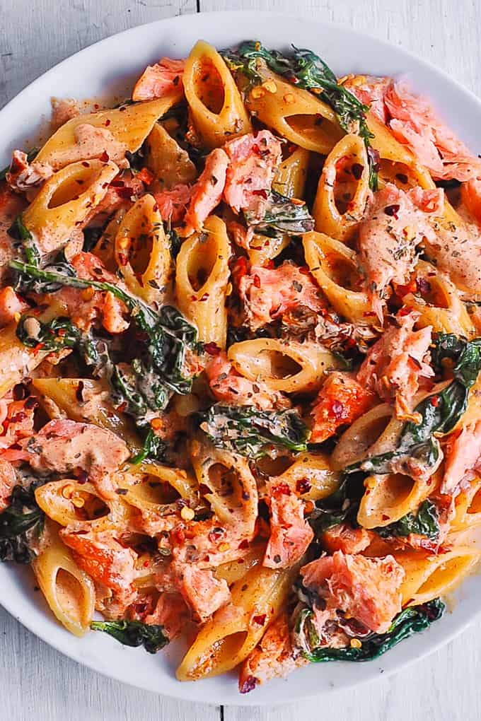 Salmon Pasta with Sun-Dried Tomato Cream Sauce and Spinach.