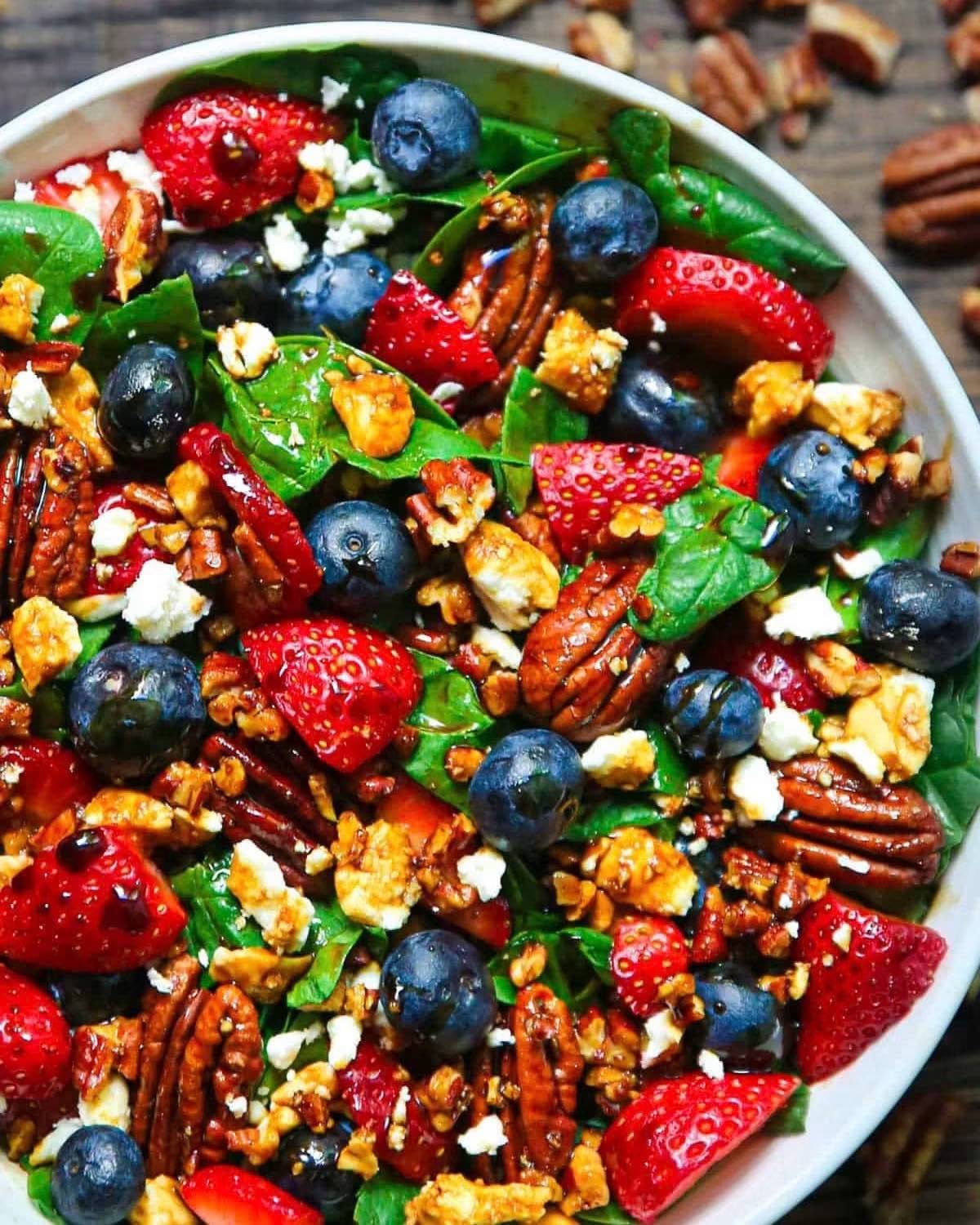 Strawberry Spinach Salad with Blueberries, Pecans and Balsamic Dressing - in a bowl.