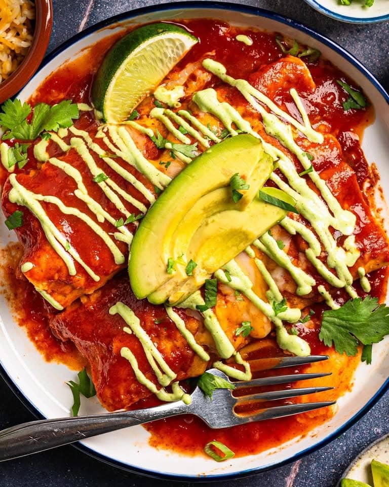 Chicken Enchiladas with Cilantro-Lime Crema on a plate.