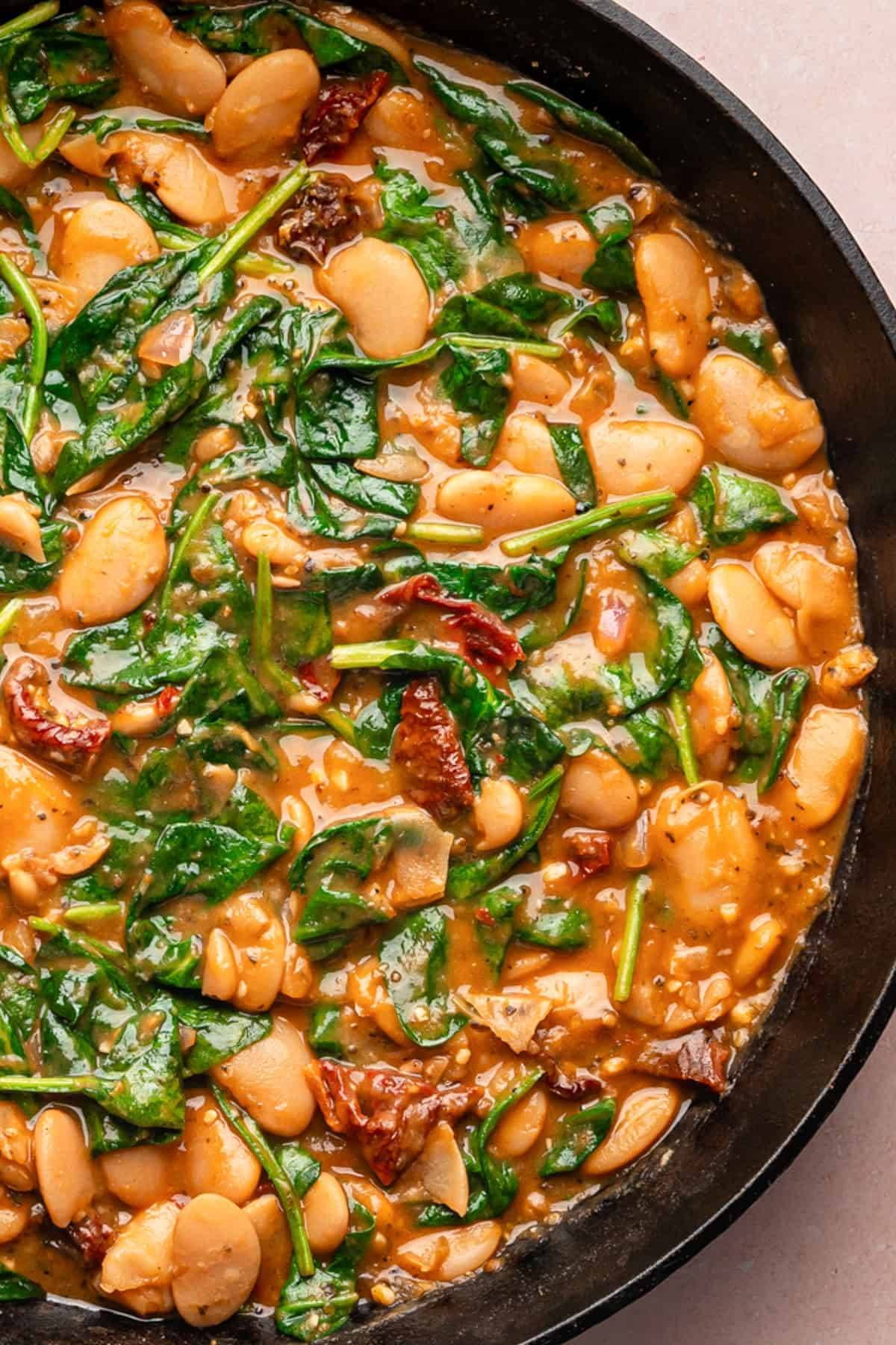 Tuscan "Marry Me" Butter Beans in a cast iron skillet.