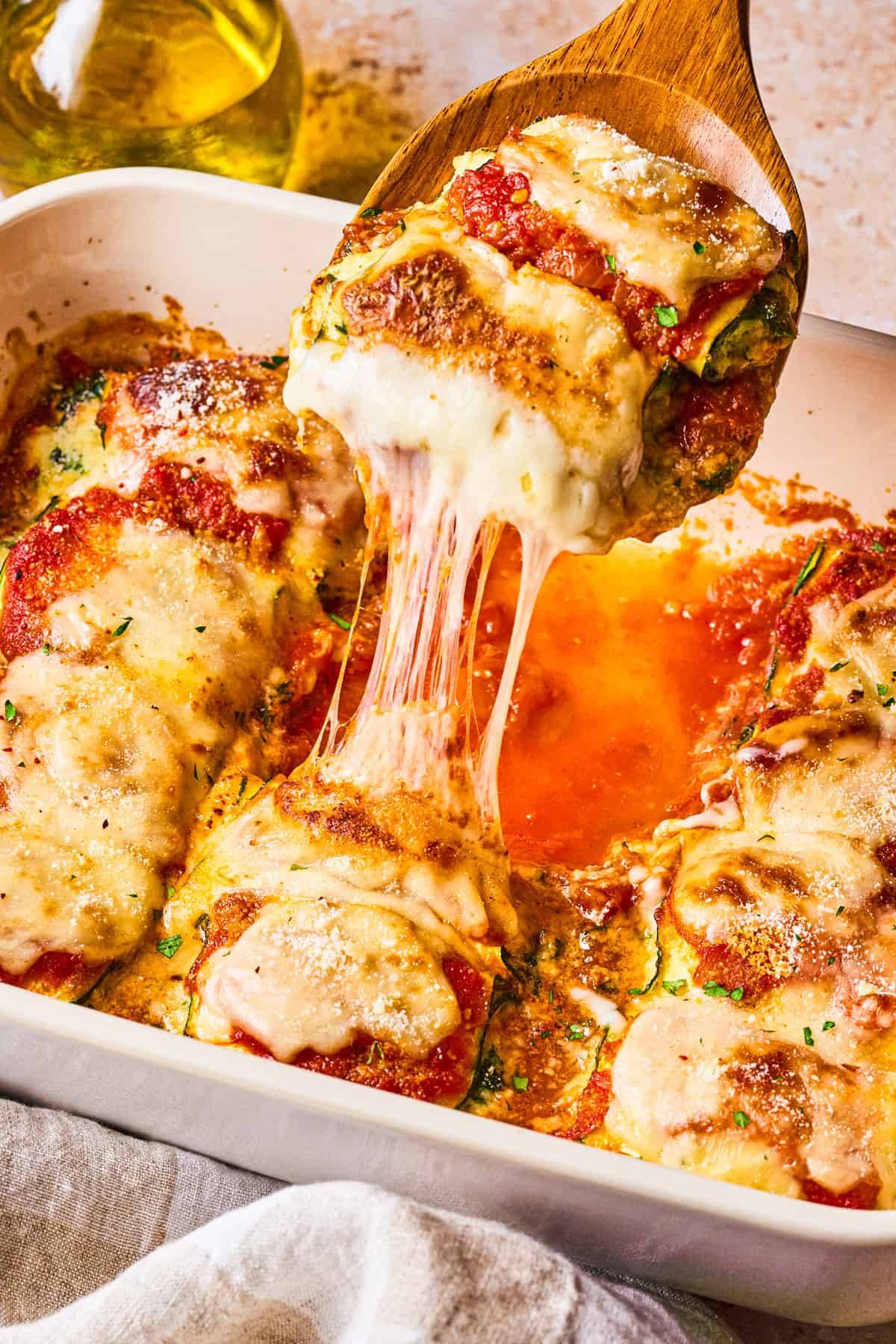 Zucchini Rollatini with Spinach and Ricotta in a white casserole dish.
