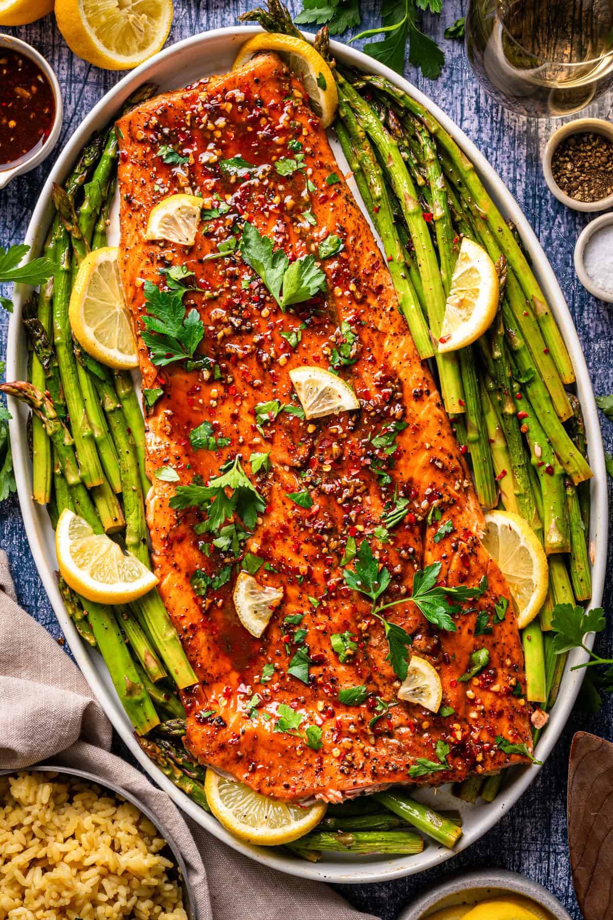 Sheet-Pan Maple Glazed Salmon with Roasted Asparagus on a white platter.