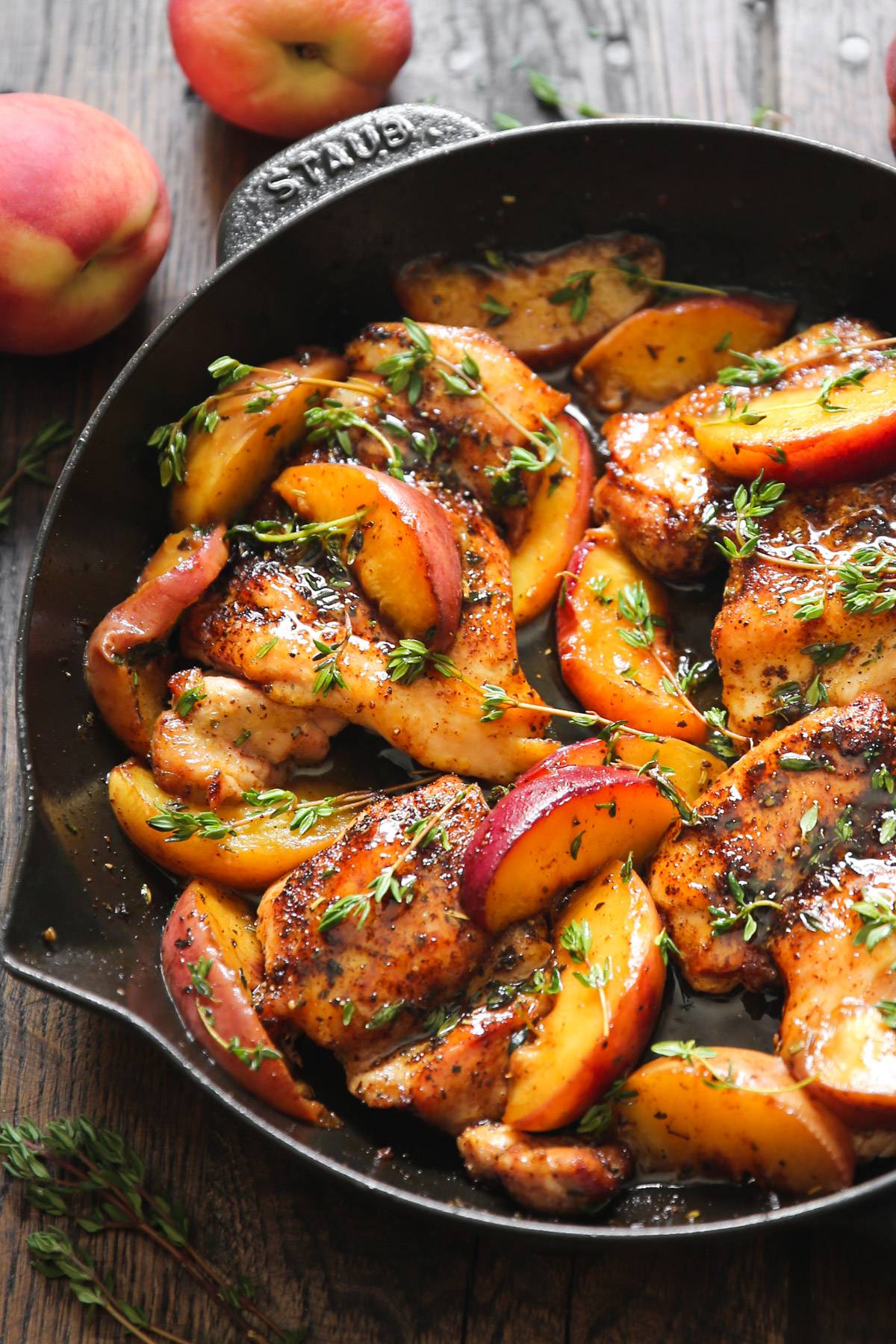 Chicken with Honey-Lemon Peaches and Thyme in a cast iron skillet. 