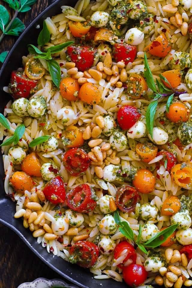 Pesto Orzo in a cast iron skillet.