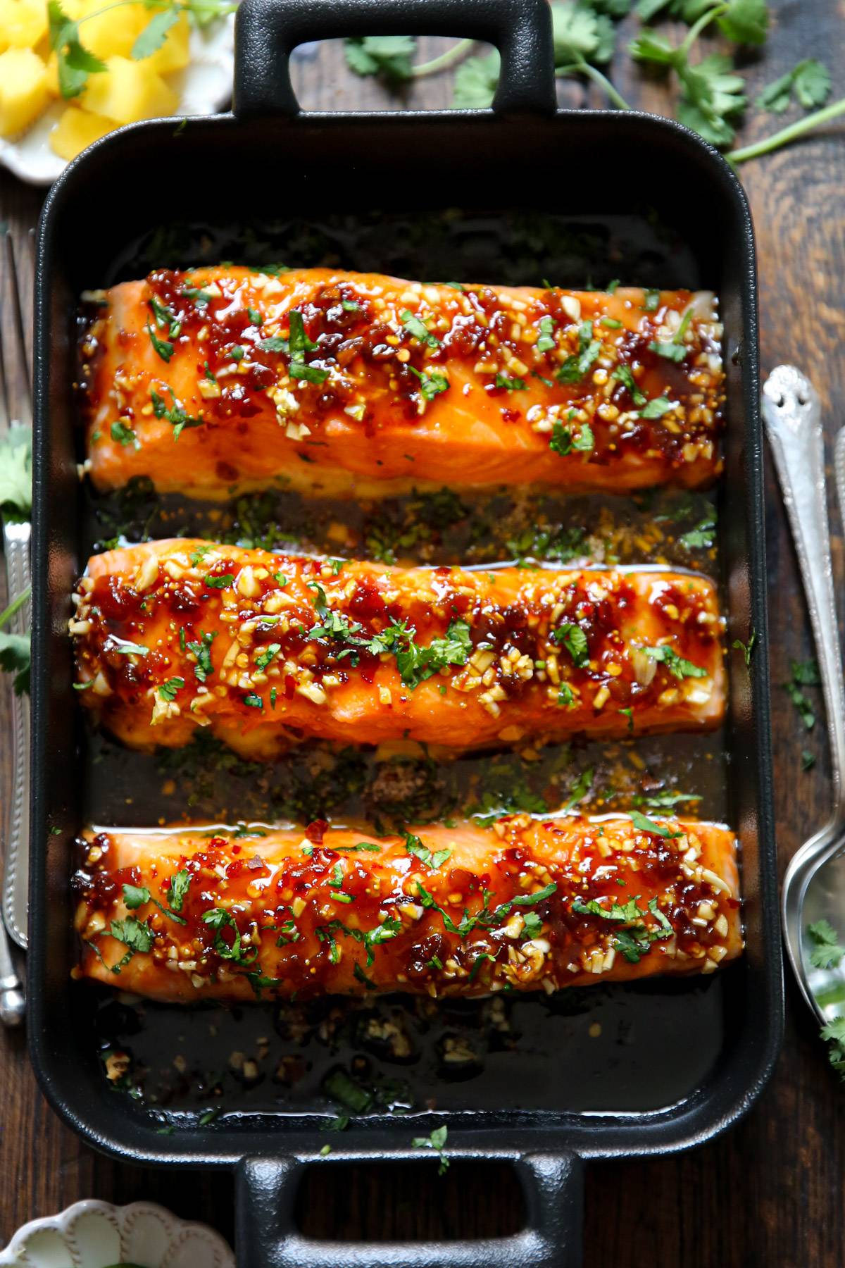 Baked Salmon with Honey Garlic Glaze and Fig Sauce - in a dark cooking pan.