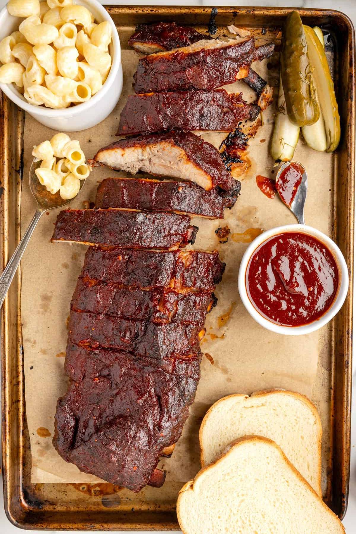 Oven-Baked Baby Back Pork Ribs (with a smoky spice rub, yellow mustard, ​homemade Kansas City barbecue sauce​).
