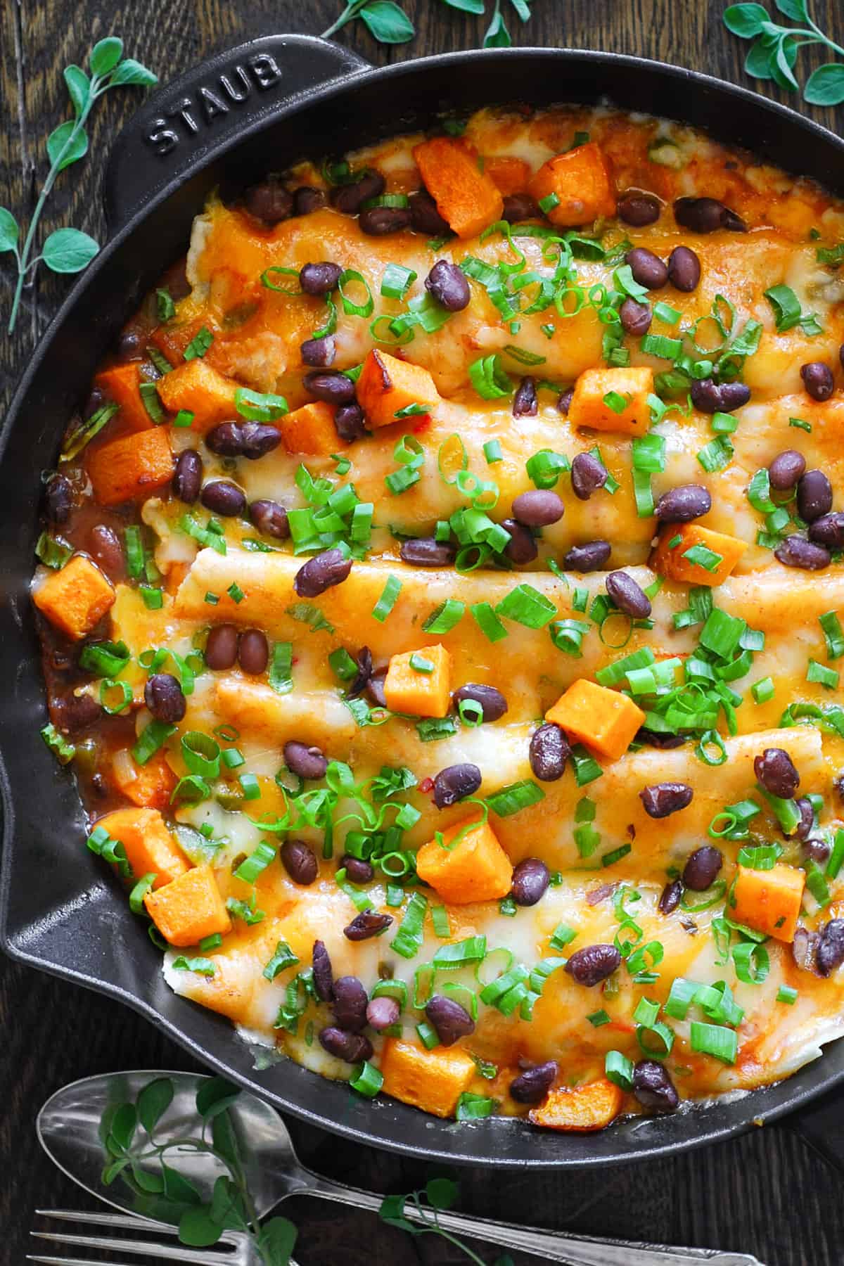Black Bean and Butternut Squash Enchiladas in a cast iron skillet.
