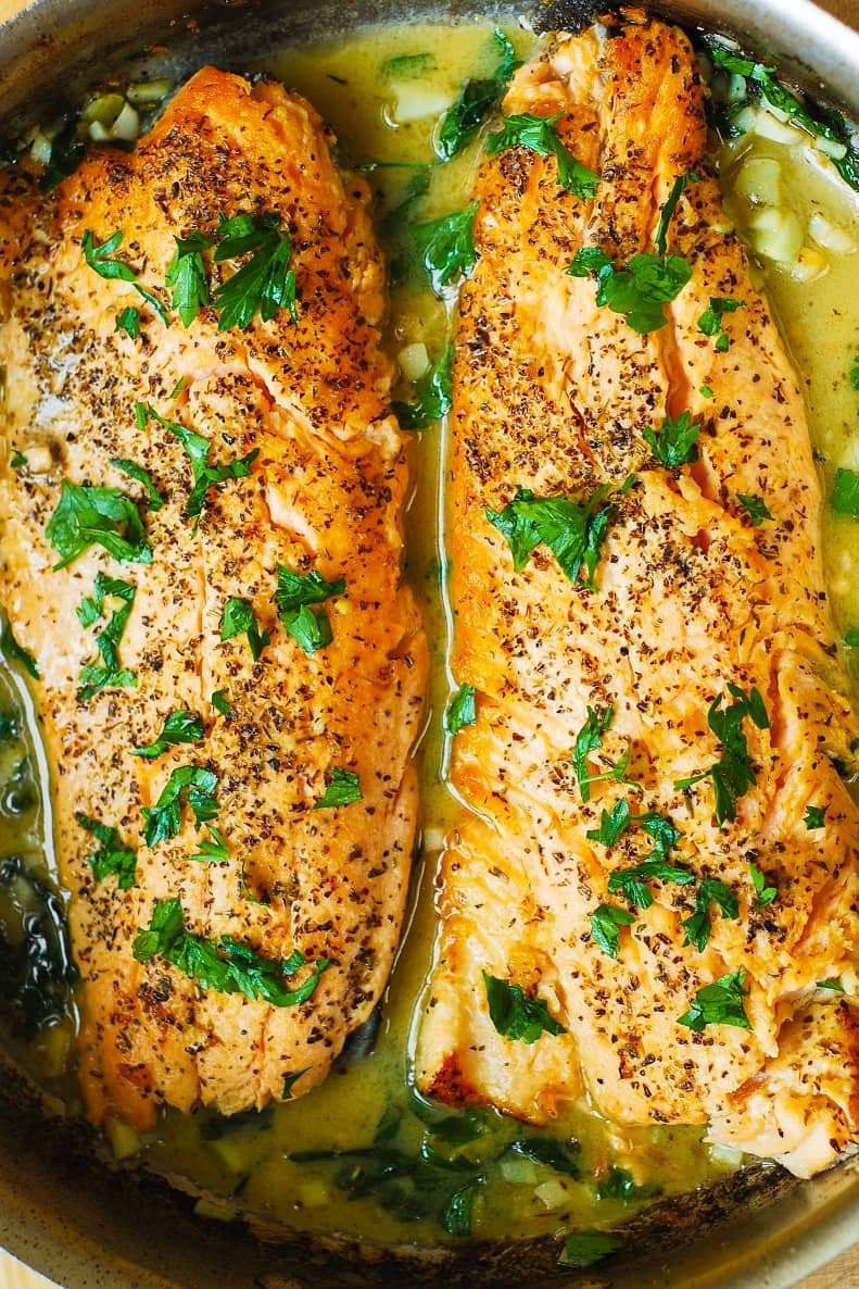 Trout Recipe with Garlic Lemon Butter Herb Sauce in a stainless steel pan.