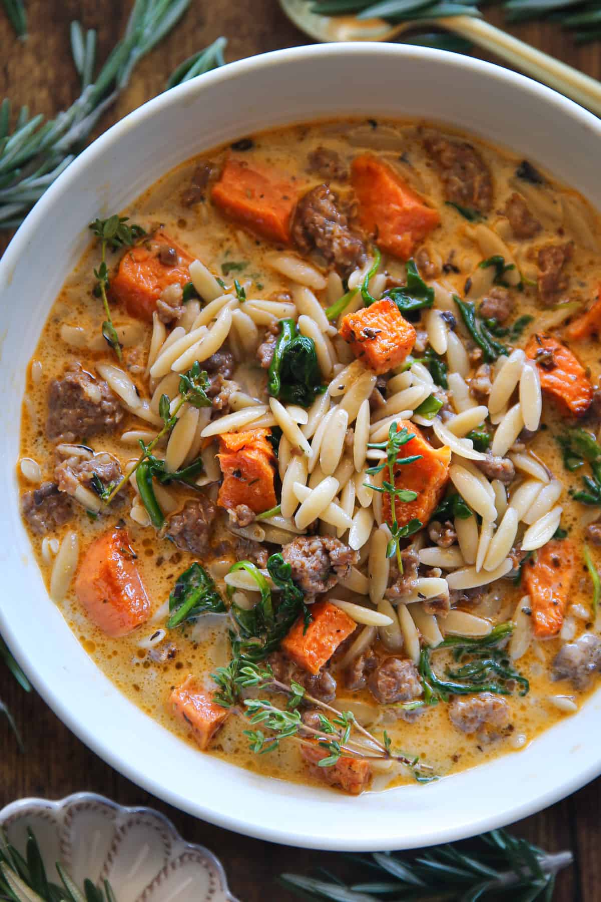 Creamy Butternut Squash and Sausage Soup with Orzo and Spinach in a bowl.