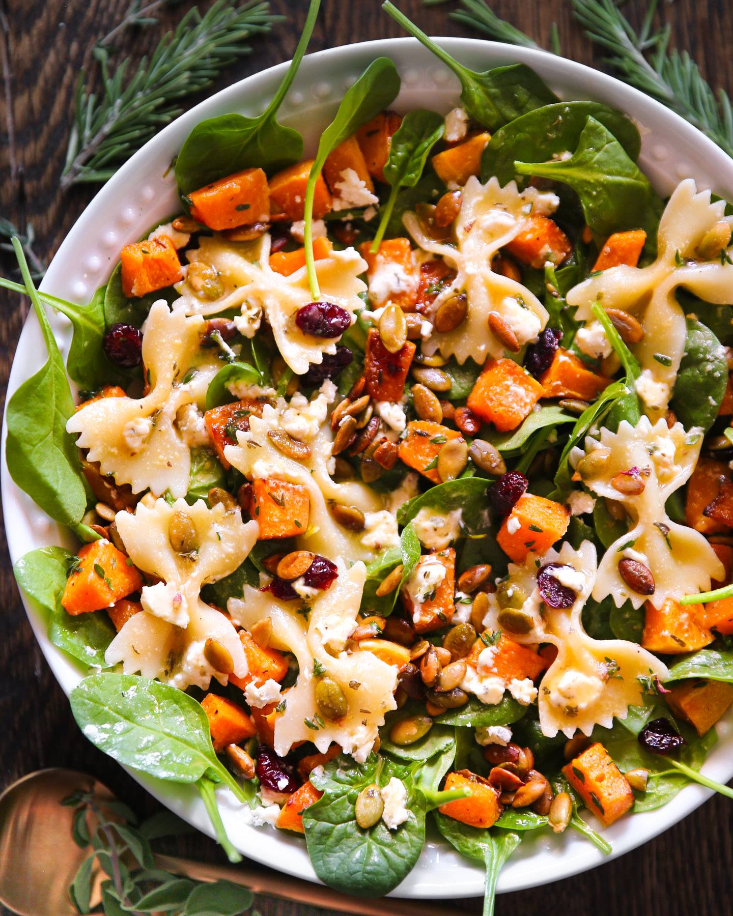 Fall Salad with Roasted Butternut Squash, Spinach, and Maple-Lime Dressing in a bowl.