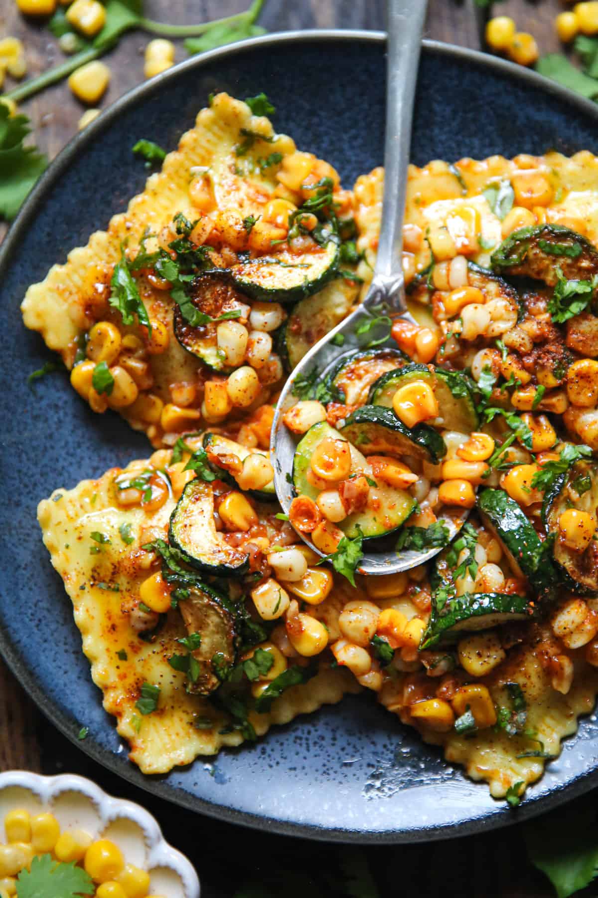 30-Minute Ravioli with Corn, Zucchini, and Garlic Butter Sauce on a blue plate.