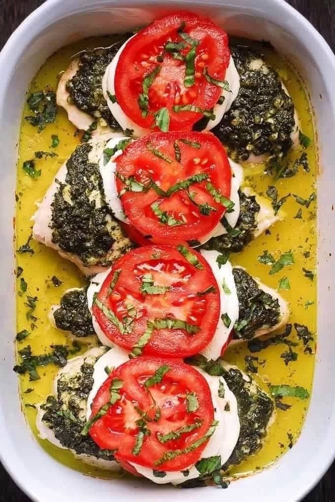Basil Pesto Tomato Mozzarella Chicken Bake in a white casserole dish.