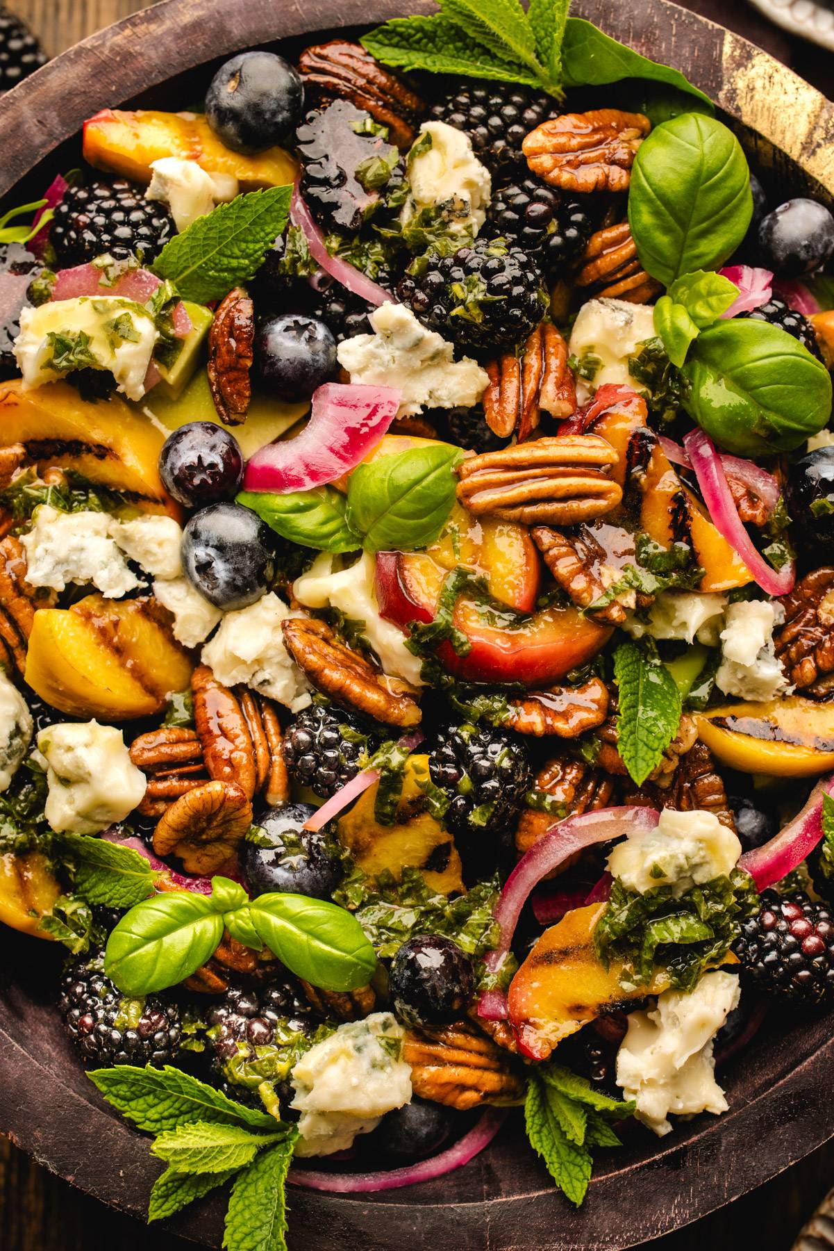 Blackberry Peach Salad with Maple Pecans and Gorgonzola Cheese in a wooden bowl.