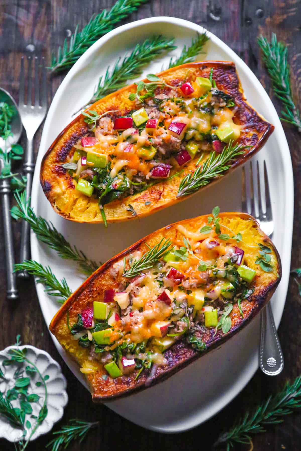 Stuffed Spaghetti Squash with spicy Italian Sausage, Spinach, Apples, Cheddar, and Pepper Jack Cheese on a plate.