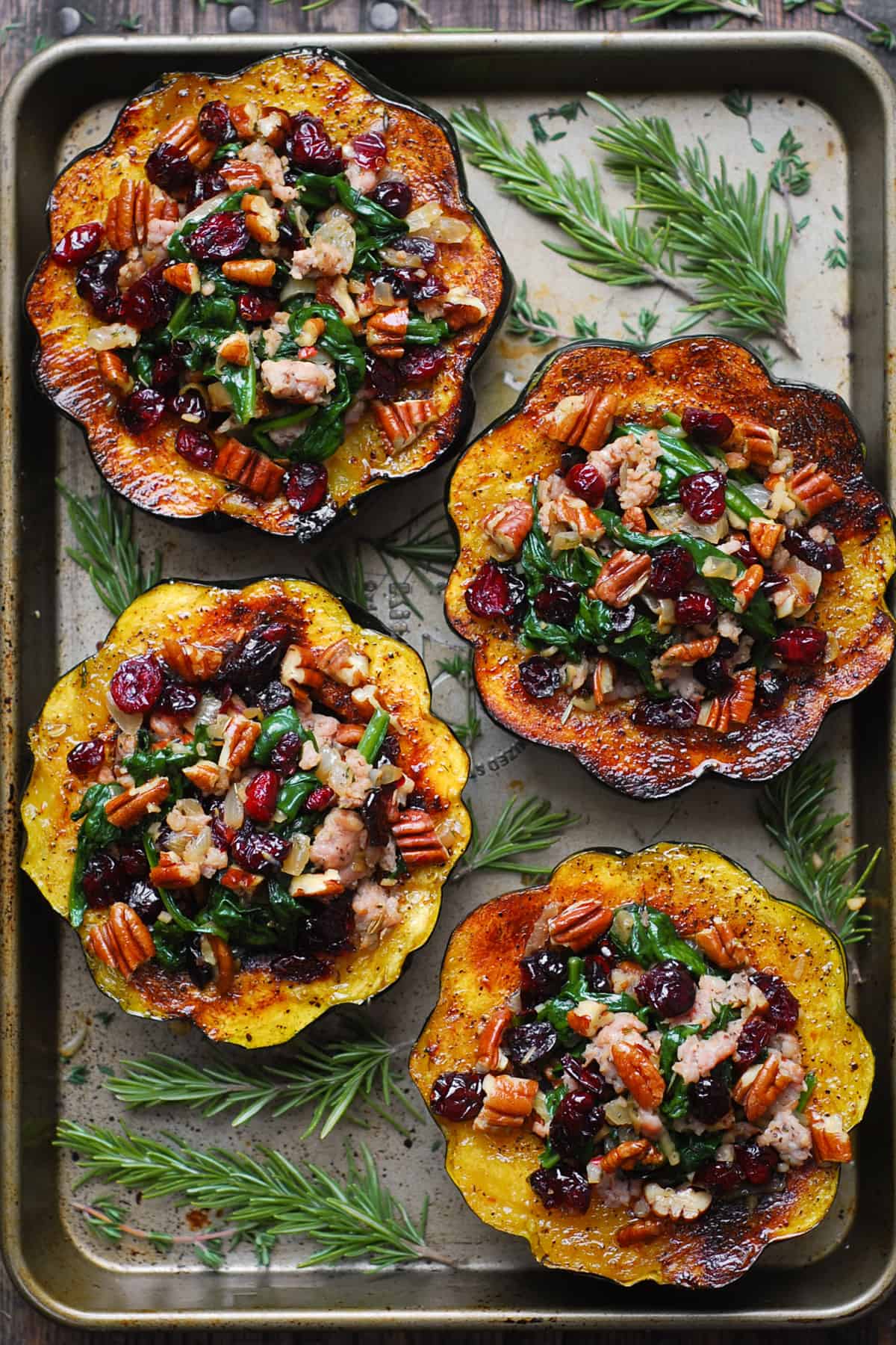 Sausage Stuffed Acorn Squash with Spinach, Cranberries, and Pecans.