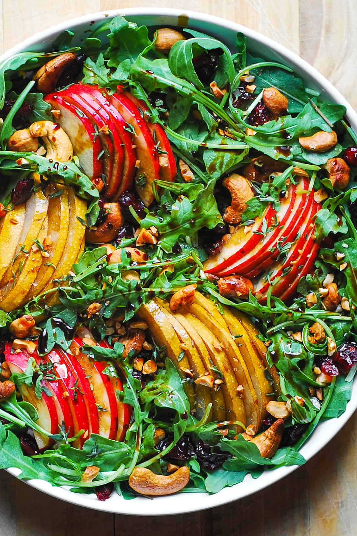 Arugula Salad with Pears, Apples, Cashews, and Balsamic Vinaigrette.