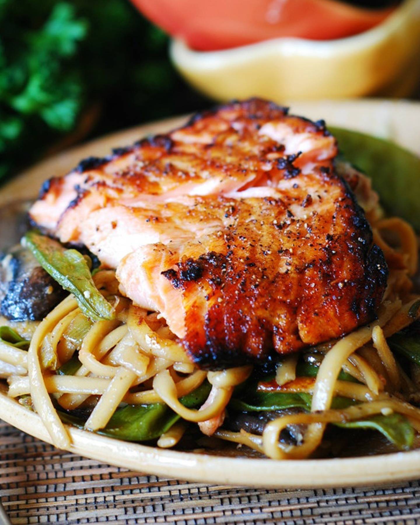 Asian Salmon and Noodles with Mushrooms and Snap Peas on a plate.