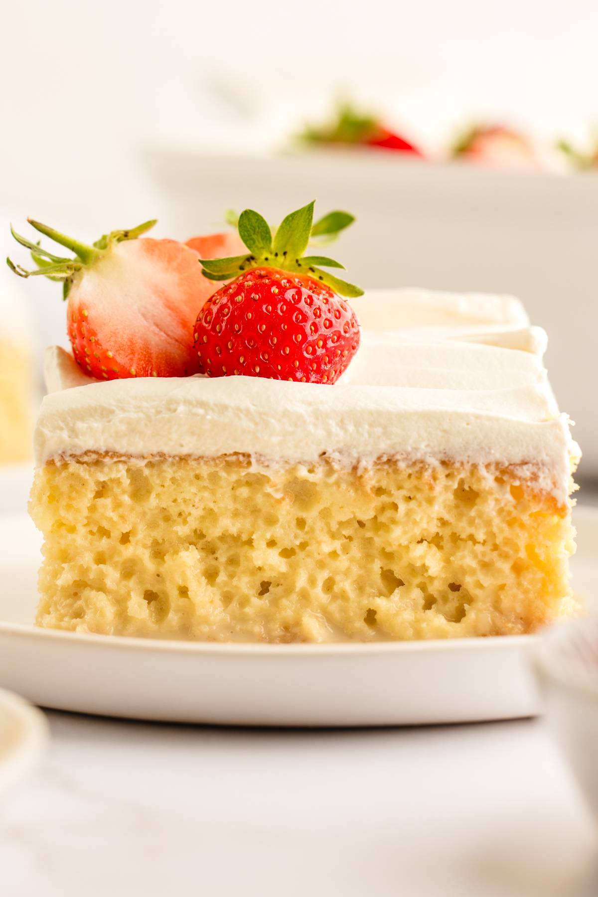 A slice of tres leches cake on a plate.